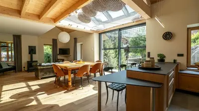 a kitchen and living room with a table and chairs at Enjoy Chalet in Chamonix-Mont-Blanc