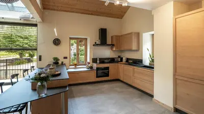 a kitchen with wooden cabinets and a counter top at Enjoy Chalet in Chamonix-Mont-Blanc