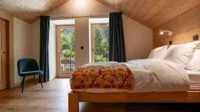 a bedroom with a large bed and a window at Enjoy Chalet in Chamonix-Mont-Blanc