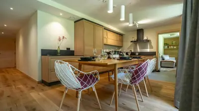 a kitchen with a wooden table and chairs at Enjoy Chalet in Chamonix-Mont-Blanc