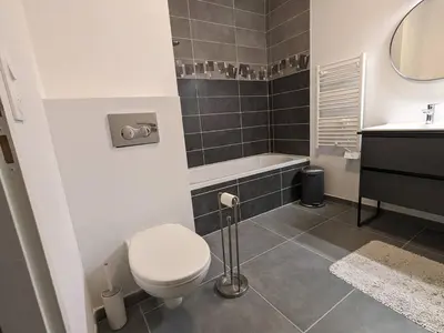 a bathroom with a toilet and a tub and a sink at Le Doran - Terrasse & Vue Mont Blanc in Sallanches