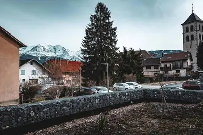 a city with cars parked on a street with a mountain at Le Doran - Terrasse & Vue Mont Blanc in Sallanches