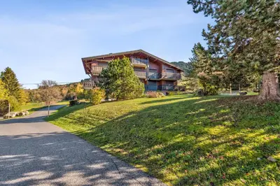a large house on a hill with a road at Appartement Bridan - Welkeys in Megève