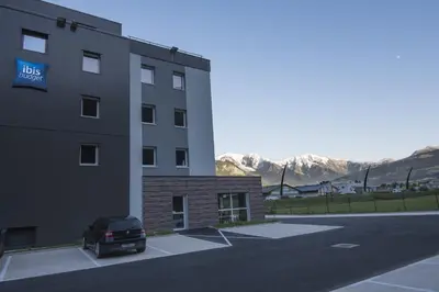 a car parked in a parking lot next to a building at Ibis Budget Sallanches in Sallanches