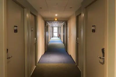 a hallway in a building with a long corridor at Ibis Budget Sallanches in Sallanches