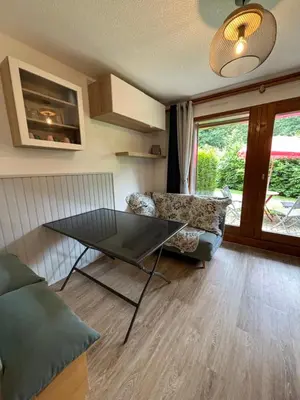 a living room with a table and a couch at Au nid du Lay in Les Contamines-Montjoie