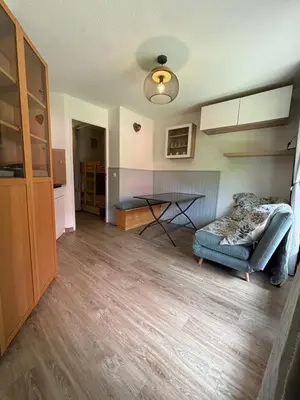 a living room with a couch and a table at Au nid du Lay in Les Contamines-Montjoie
