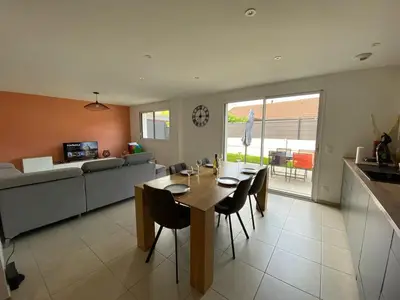 a dining room and living room with a table and chairs at Le Mariloz - Vacances famille ski & montagne in Passy