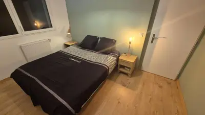 a bedroom with a large bed in a room at Le Mariloz - Vacances famille ski & montagne in Passy