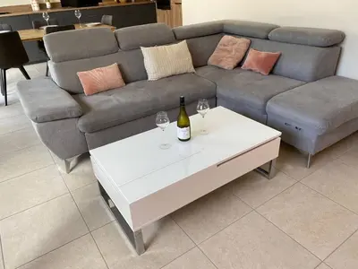 a living room with a couch and a table with wine glasses at Le Mariloz - Vacances famille ski & montagne in Passy