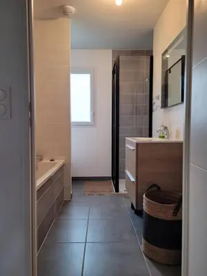 a bathroom with a tub and a sink at Le Mariloz - Vacances famille ski & montagne in Passy