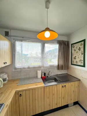 a kitchen with a sink and a light at Charming studio near the slopes and the city in Megève