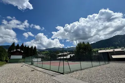 a tennis court with a net on top of it at Charming studio near the slopes and the city in Megève