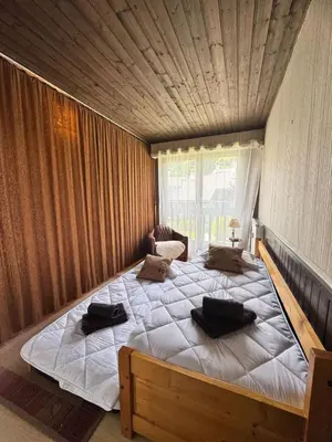 a bedroom with a large bed with two pillows on it at Charming studio near the slopes and the city in Megève