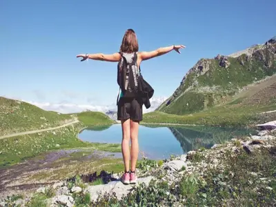 a woman standing on top of a mountain with her arms outstretched at Charming Mountain Getaway in Samoëns