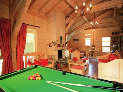 a room with wooden walls and tables and a computer at Charming Mountain Getaway in Samoëns