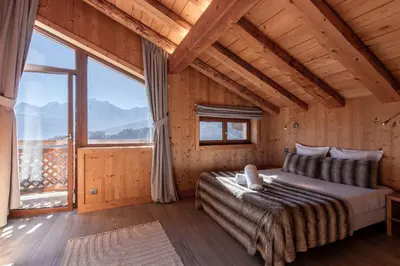 a bedroom with a bed and a large window at Chalet Mont Blanc in Cordon