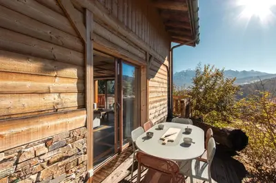 a table and chairs on the porch of a cabin at Chalet Mont Blanc in Cordon
