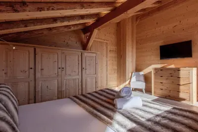 a bedroom with a bed in a wooden cabin at Chalet Mont Blanc in Cordon