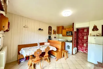 a kitchen with a table and chairs in it at La Terrasse du Sapin in Combloux