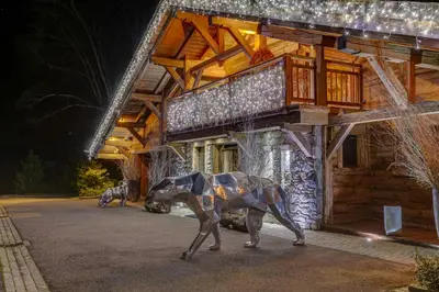a statue of a dog in front of a building at Megeve Luxury Estate The Royal Alpine Retreat with Mont Blanc View - Chalet Maille in Demi-Quartier