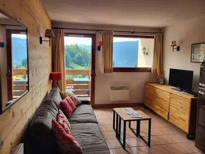 a living room with a couch and a television at Jardins Alpins A N 20 - 2P6 in Morillon