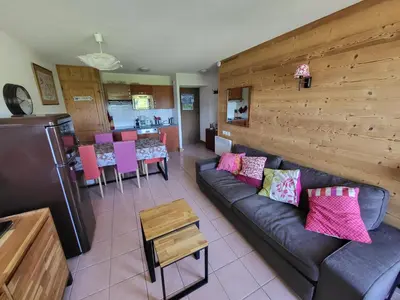 a living room with a couch and a kitchen at Jardins Alpins A N 20 - 2P6 in Morillon