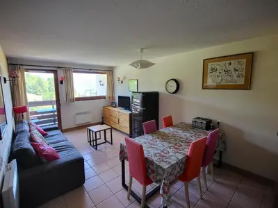 a living room with a table and a couch at Jardins Alpins A N 20 - 2P6 in Morillon