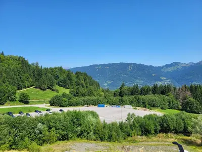 a parking lot with a bunch of cars parked at Jardins Alpins A N 20 - 2P6 in Morillon