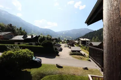 a view of a village with mountains in the background at Résidence Les Chamois - Les Chamois MAE-0143 in Les Houches