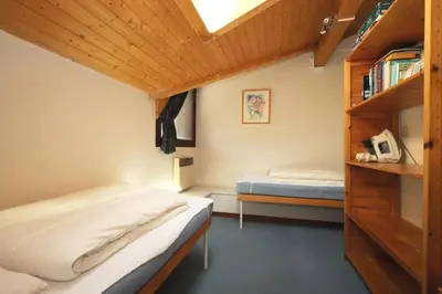a bedroom with two beds and a book shelf at Résidence Les Chamois - Les Chamois MAE-0143 in Les Houches