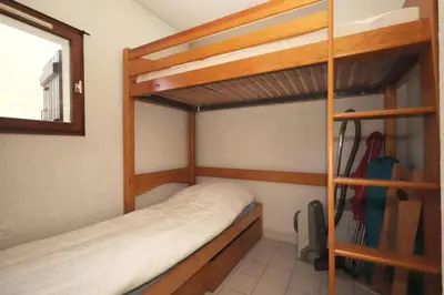 a bedroom with two bunk beds and a window at Résidence Les Chamois - Les Chamois MAE-0143 in Les Houches