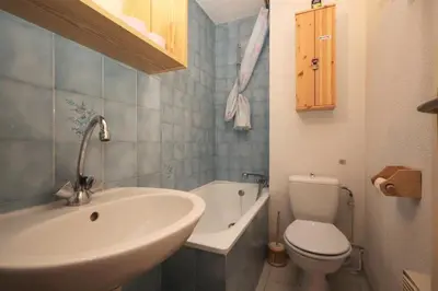 a bathroom with a sink and a toilet and a tub at Résidence Les Chamois - Les Chamois MAE-0143 in Les Houches