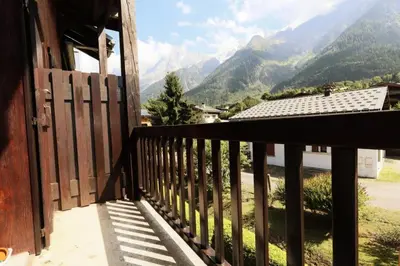 a balcony of a house with a view of mountains at Résidence Les Chamois - Les Chamois MAE-0143 in Les Houches