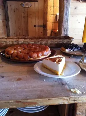 a table with a slice of cake and pastries on it at Appartement 10 personnes au pied des pistes vue Mont Blanc in Combloux