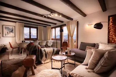 a living room with a couch and a table at Appartement 10 personnes au pied des pistes vue Mont Blanc in Combloux