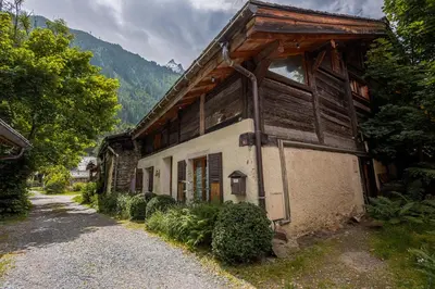 an old wooden house on the side of a road at Chalet Pele - Alpes Travel - Sleeps 11 in Chamonix-Mont-Blanc