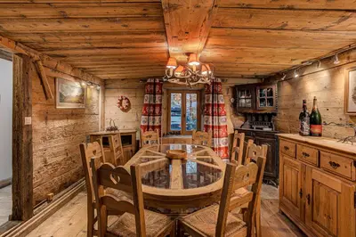 a dining room with a table and chairs in a cabin at Chalet Pele - Alpes Travel - Sleeps 11 in Chamonix-Mont-Blanc