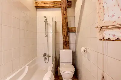 a bathroom with a toilet and a bath tub at Chalet Pele - Alpes Travel - Sleeps 11 in Chamonix-Mont-Blanc