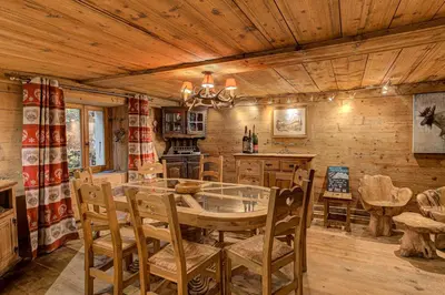 a dining room and kitchen with a table and chairs at Chalet Pele - Alpes Travel - Sleeps 11 in Chamonix-Mont-Blanc