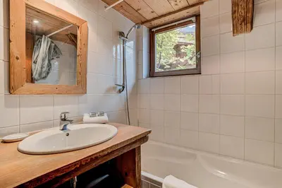 a bathroom with a sink and a tub at Chalet Pele - Alpes Travel - Sleeps 11 in Chamonix-Mont-Blanc