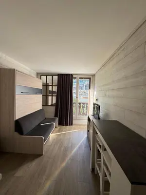 a living room with a couch and a window at L'appart 313 - La Forclaz in Chamonix-Mont-Blanc