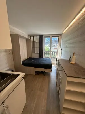 a small room with a bed and a kitchen at L'appart 313 - La Forclaz in Chamonix-Mont-Blanc