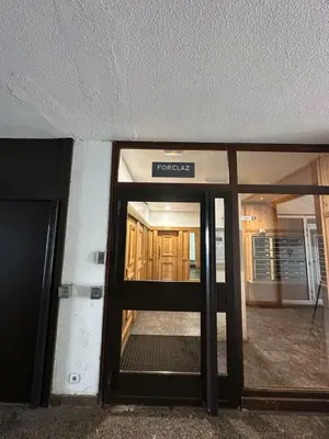 an open door to a building with a sign on it at L'appart 313 - La Forclaz in Chamonix-Mont-Blanc