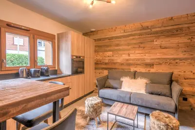 a living room with a couch and a table at Studio Berrier - Welkeys in Megève
