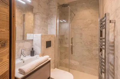 a bathroom with a shower and a sink and a toilet at Studio Berrier - Welkeys in Megève