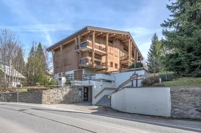 a house on the side of a road at Appartement Vinson - Welkeys in Megève