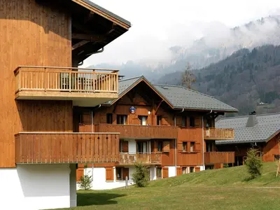 a sauna with wood paneled walls and wooden floors at Mountain Retreat for Families in Samoëns