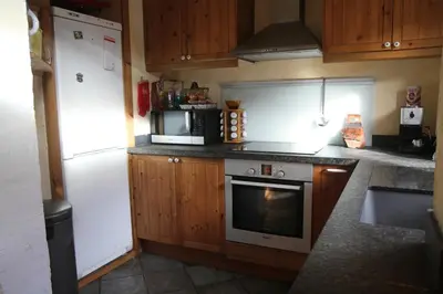 a kitchen with a white refrigerator and a microwave at Nos Maisons Cosy - Vallorcine in Vallorcine