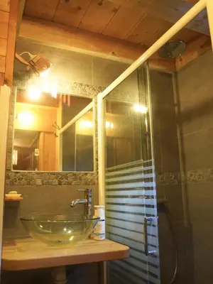 a bathroom with a glass sink and a shower at Nos Maisons Cosy - Vallorcine in Vallorcine